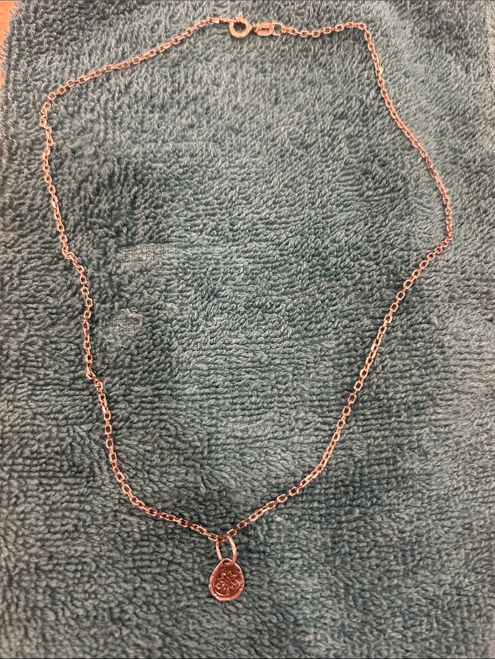 Sterling silver cable chain and pendant.